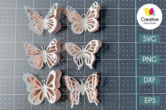 Layered paper butterflies crafted from butterfly clipart templates in SVG, PNG, DXF, and EPS formats on a cutting mat