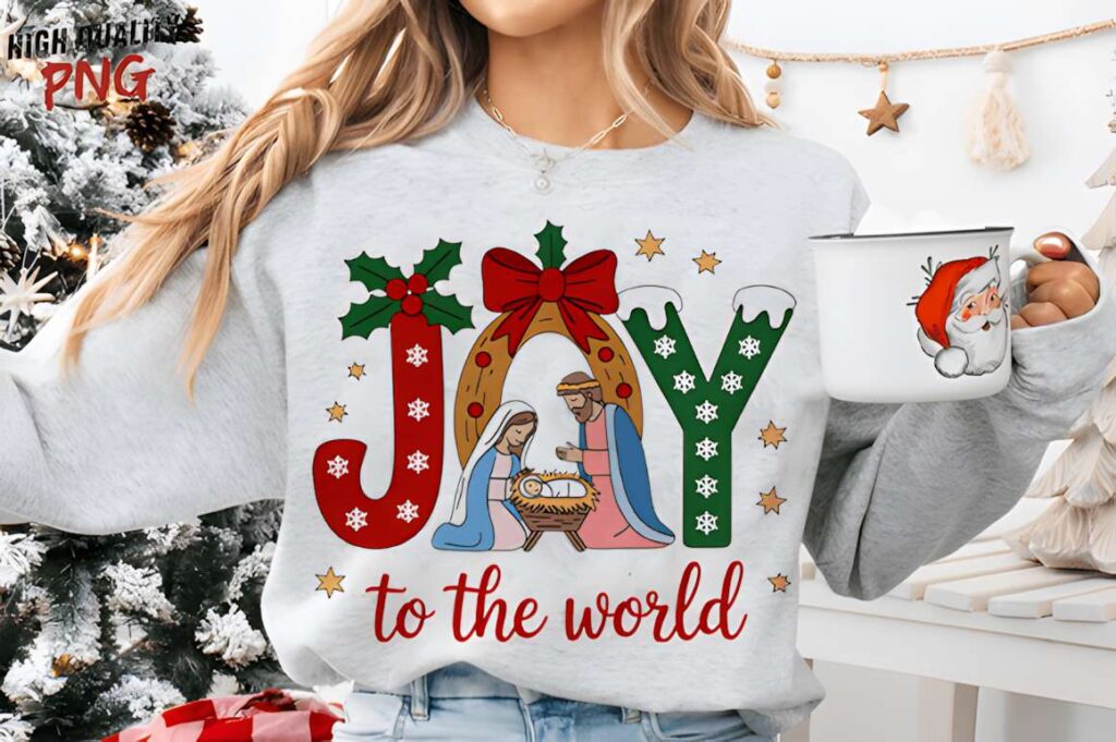 Christmas t-shirt design ideas for POD sellers featuring JOY with nativity scene and holly on sweatshirt