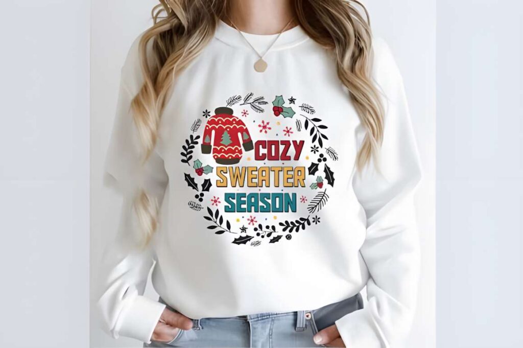 Christmas t-shirt design ideas for POD sellers cozy sweater season graphic on white sweatshirt